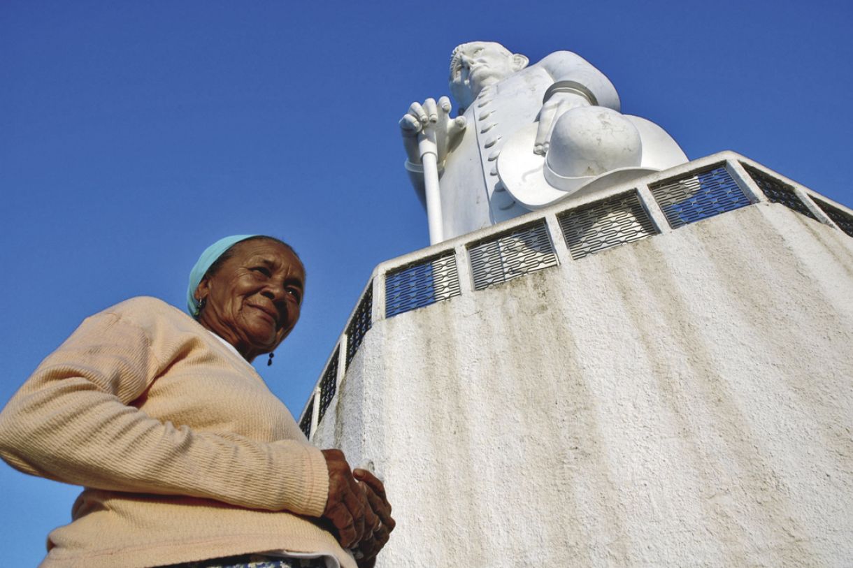 Romeiros fazem pose diante da estátua de concreto de 27 metros de altura do religioso